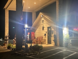 Un edificio pequeño con un letrero atractivo, un letrero de Coca-Cola y una decoración con estrella en la pared.