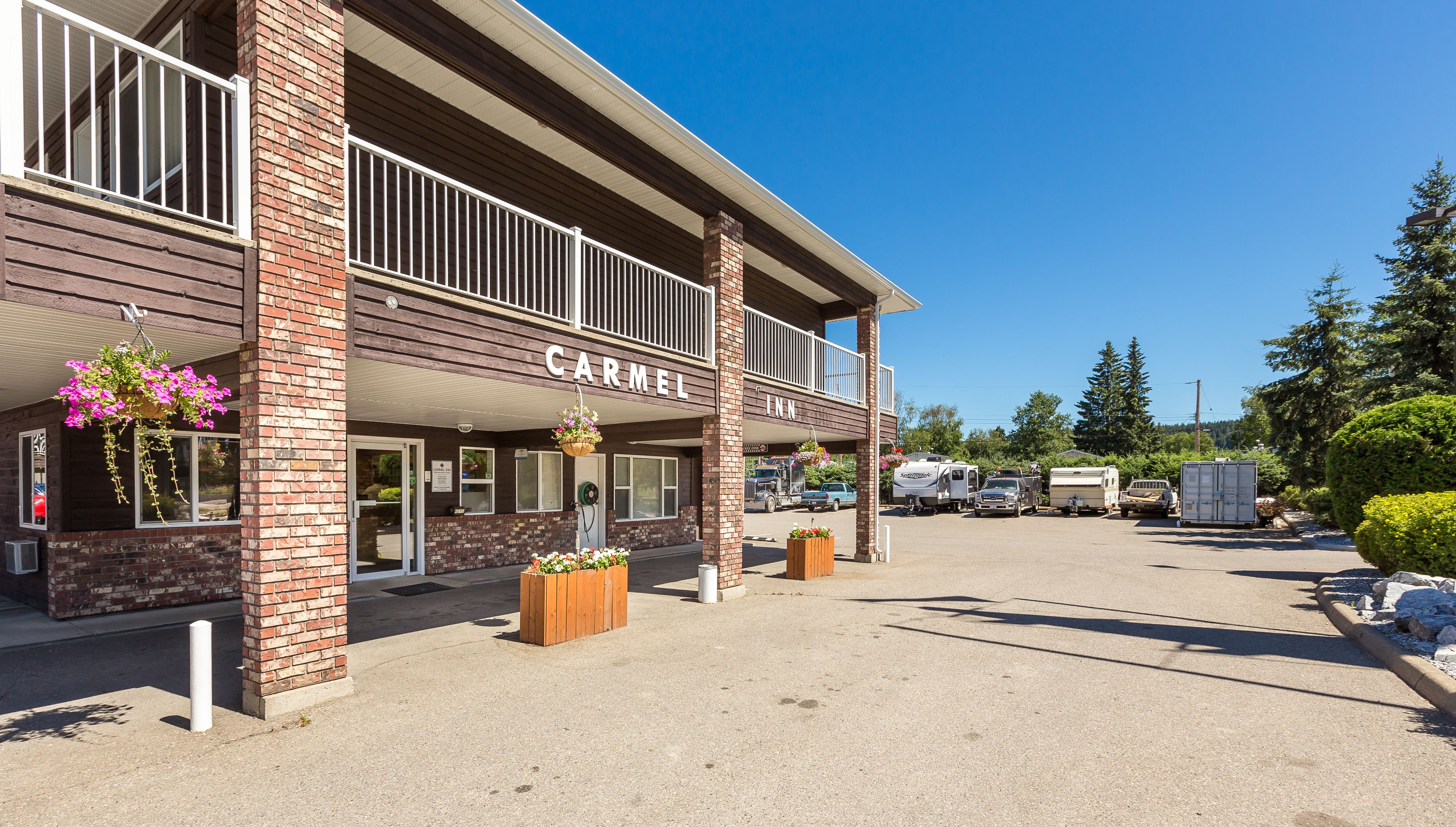A two-story building with a sign reading "CARMEL INN".