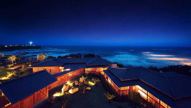 A coastal resort with multiple buildings, each featuring a sloped roof and a view of the ocean. - Hotel Bettei Umi To Mori (Choshi)
