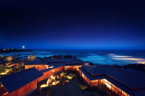 A coastal resort with multiple buildings, each featuring a sloped roof and a view of the ocean. - Hotel Bettei Umi To Mori (Choshi)