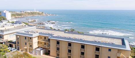 A coastal building with multiple balconies overlooking the sea.