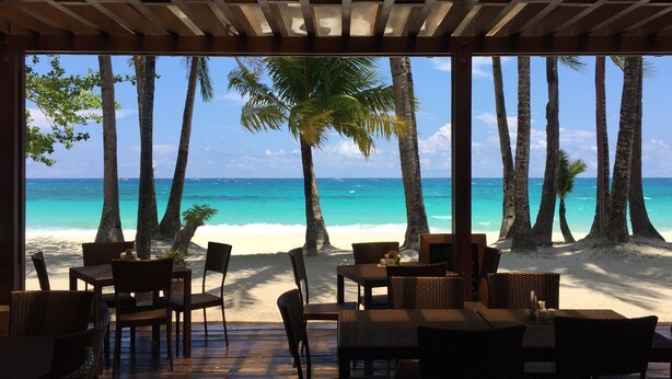 A beachside restaurant with outdoor seating, palm trees, and a view of the ocean. - 357 Boracay (Boracay Island)