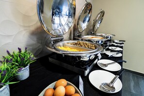 A buffet setup with various food items and utensils. - Argus Hotel Darwin (Darwin)