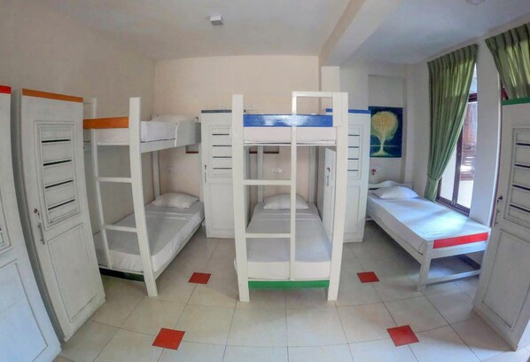 A room with bunk beds, a desk, and a window with curtains. - Insight resort (Ahangama)
