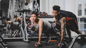 A gym with exercise equipment, including dumbbells and a squat rack.