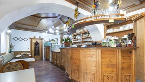 A restaurant with wooden decor, a bar area, and seating for guests. - Rifugio Monte Baldo (Avio)