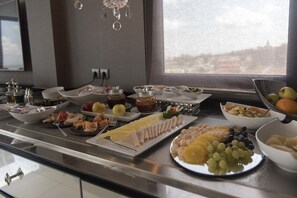 A buffet with various food items and utensils.