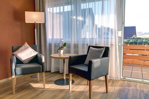 Comfort Double Room, 1 Bedroom | Living area | Flat-screen TV