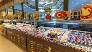 A buffet with various food items and decorative fruit carvings. - L'ancora Beach Hotel (Kemer)