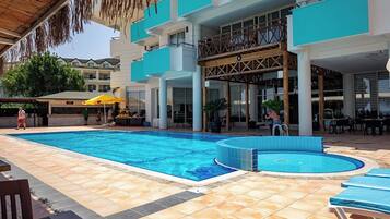 Seasonal outdoor pool, open 10:00 AM to 6:00 PM, pool umbrellas