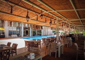 Seasonal outdoor pool, open 10:00 AM to 6:00 PM, pool umbrellas