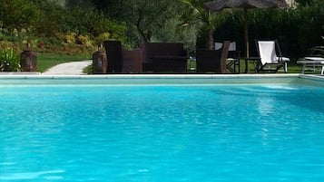 Seasonal outdoor pool, pool umbrellas, pool loungers