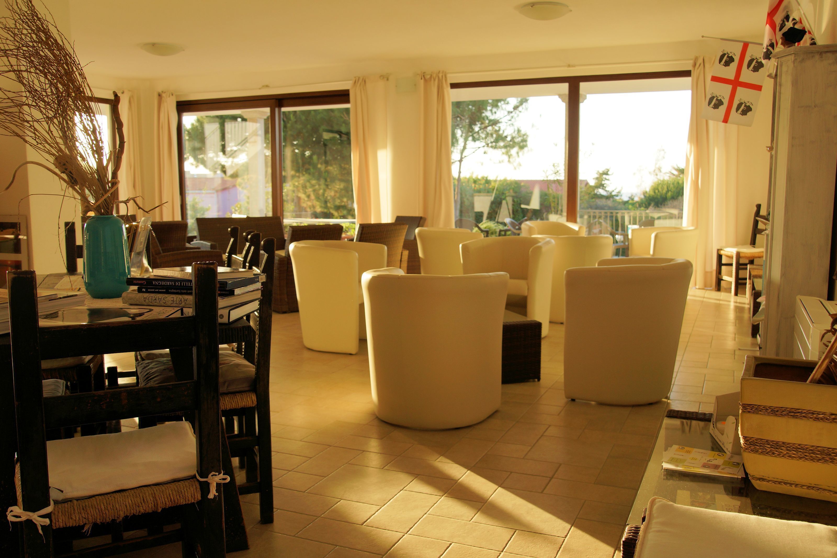 A spacious living room with a dining area, large windows, and a view of the outdoors.