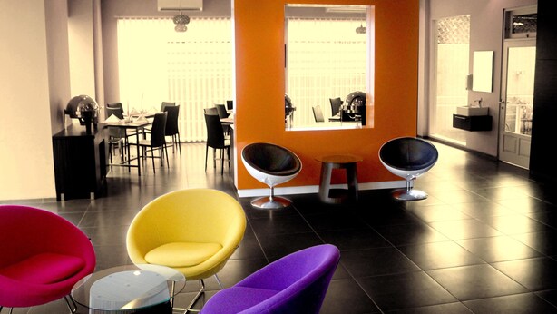 A modern interior with a reception area, a dining space, and a bathroom.
