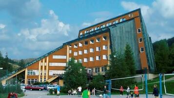 A hotel with multiple floors and a large glass facade.