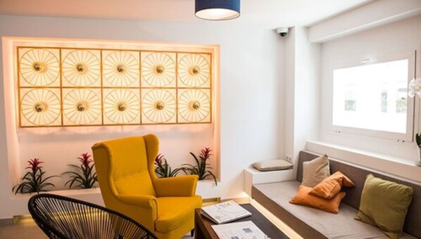 A modern living room with a yellow armchair, a sofa with cushions, a coffee table, and a decorative wall panel.