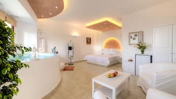 Relax in a spacious room with a large bed, sitting area, and separate bathroom.