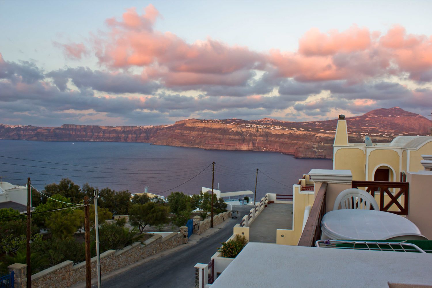 A coastal road with a view of cliffs and the sea.