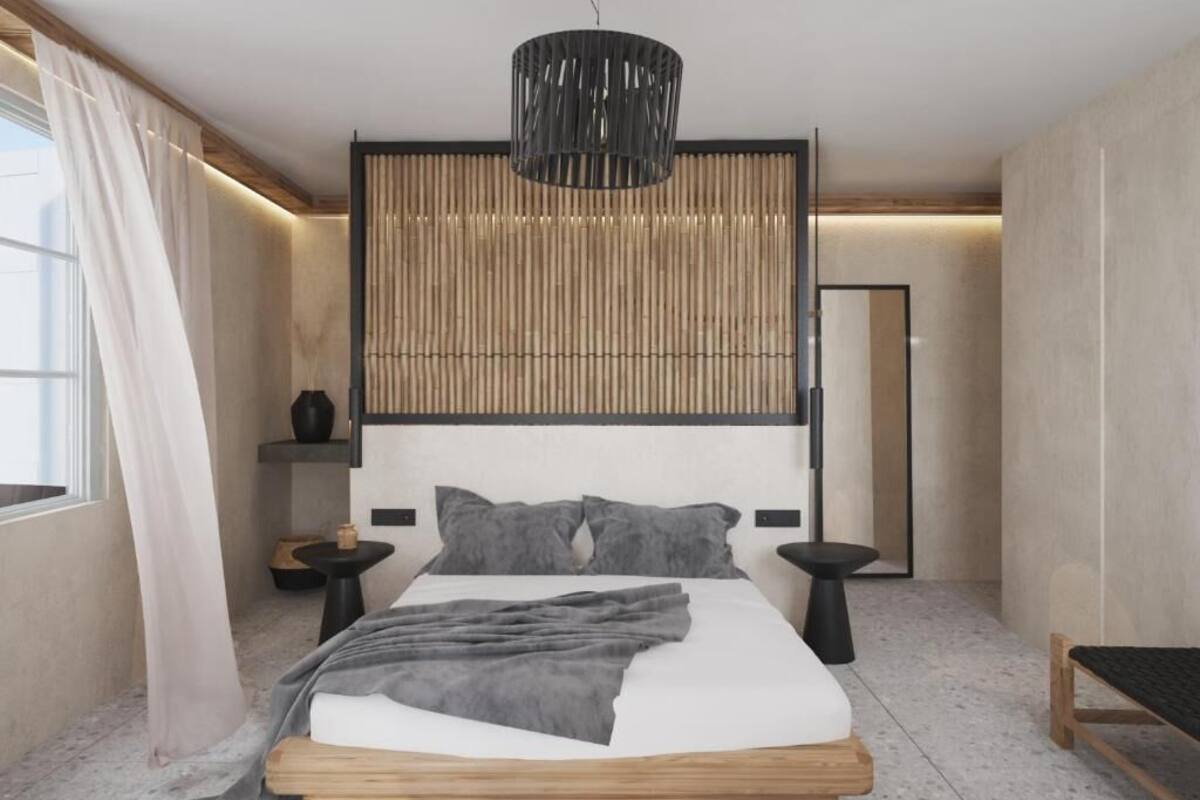 A modern bedroom with a large bed, bedside tables, a hanging light fixture, and a view of the outside.