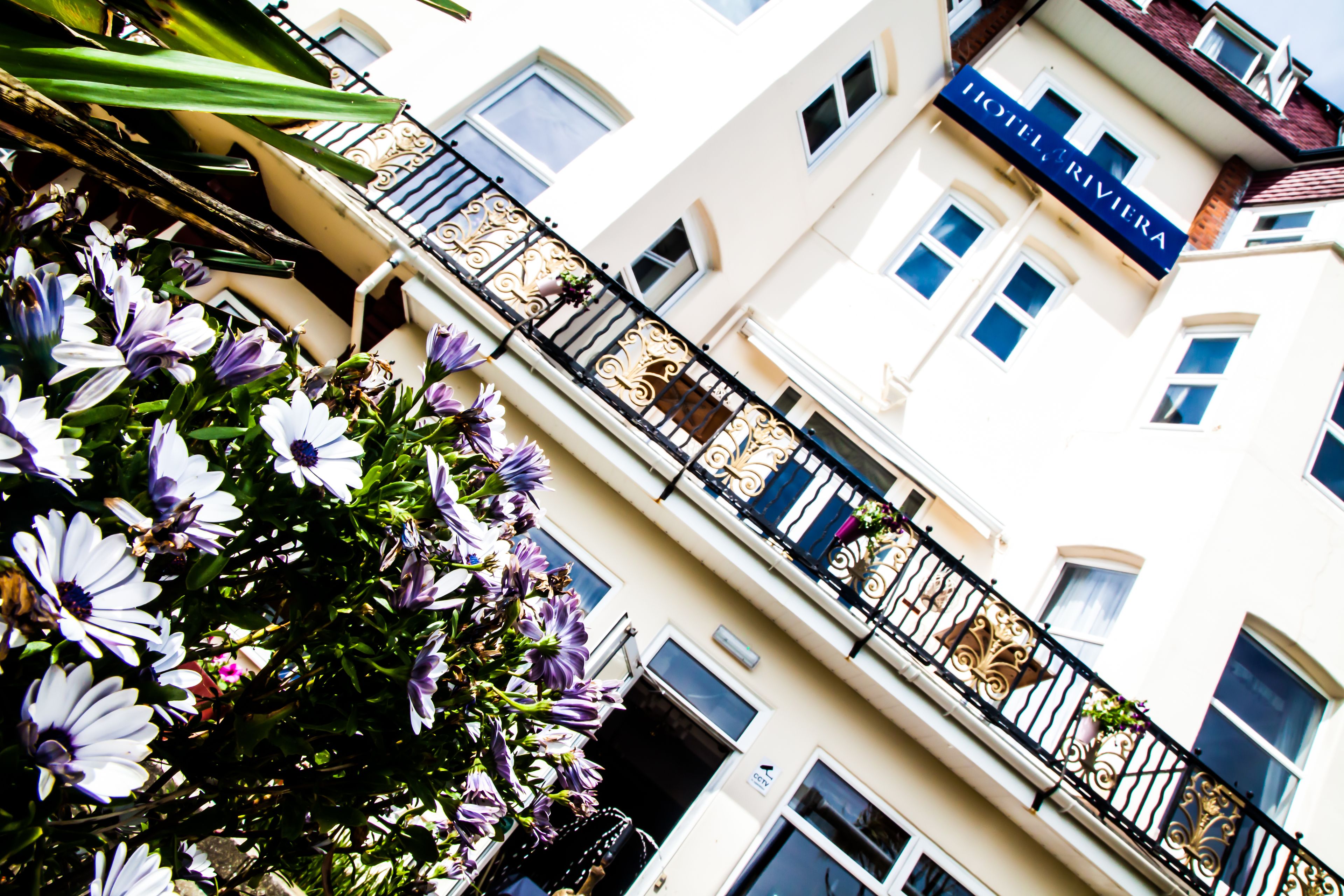 A building with a balcony and a sign that reads "HOTEL RIVIERA".