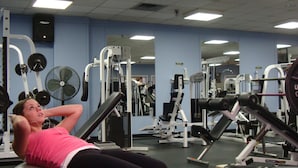 A gym with exercise equipment, mirrors, and a ceiling with fluorescent lights. - Mount Saint Vincent University Residence - Hostel (Halifax)