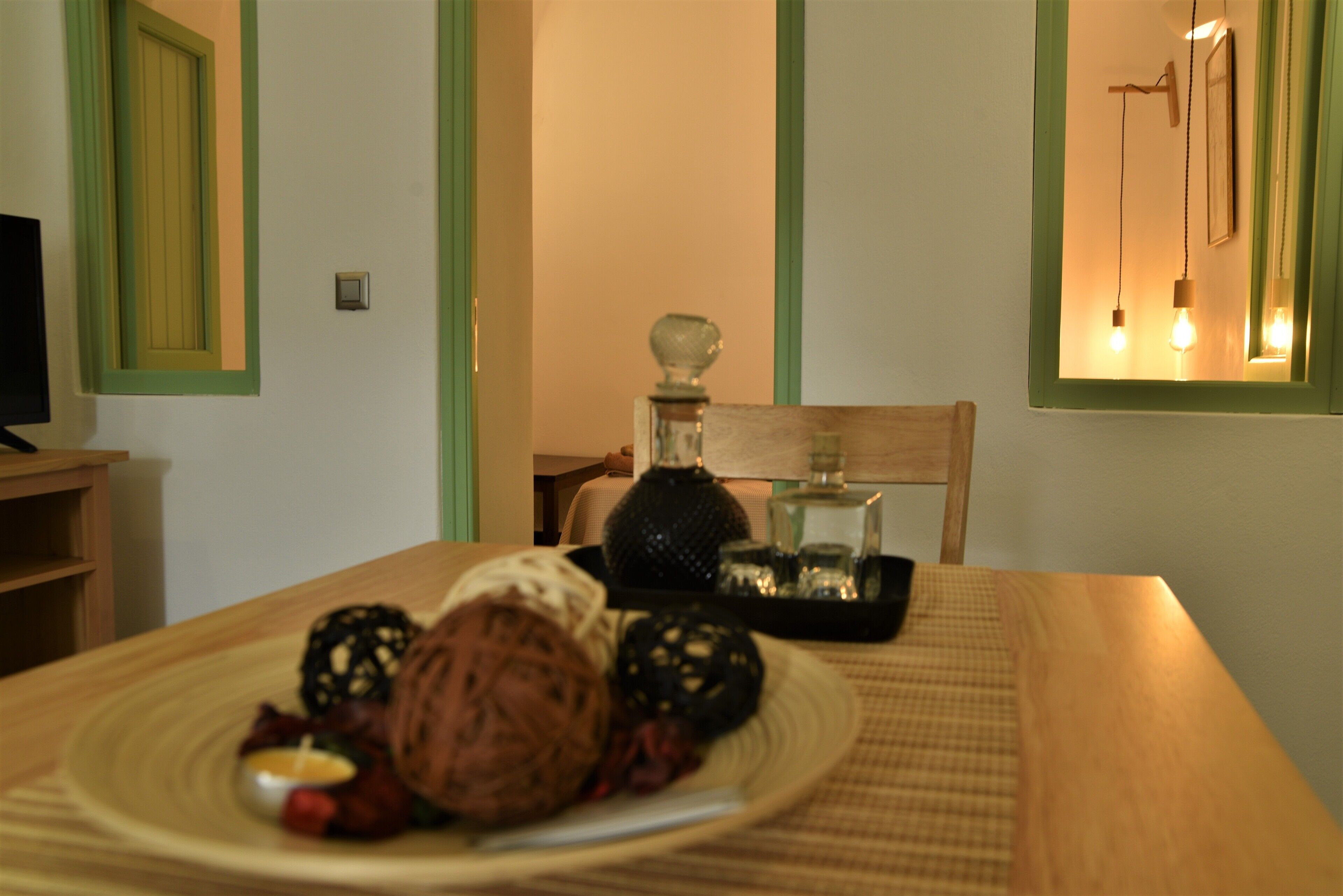 A dining table with a plate of food, a candle, and a decorative item.