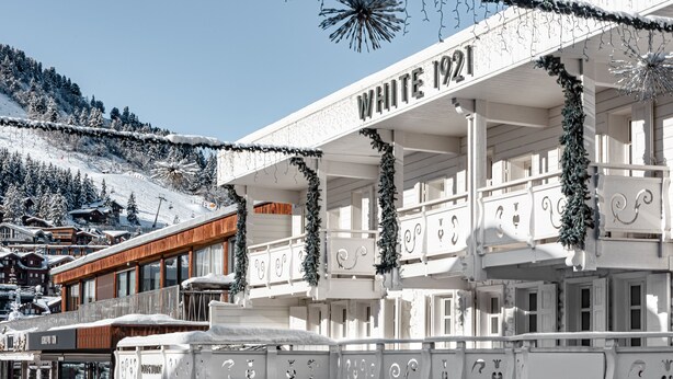 A building with the sign "WHITE 1921" and a balcony with decorative garlands. - White 1921 Courchevel (Courchevel)