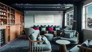 A modern living room with a sofa set, a coffee table, and a bookshelf. - White 1921 Courchevel (Courchevel)