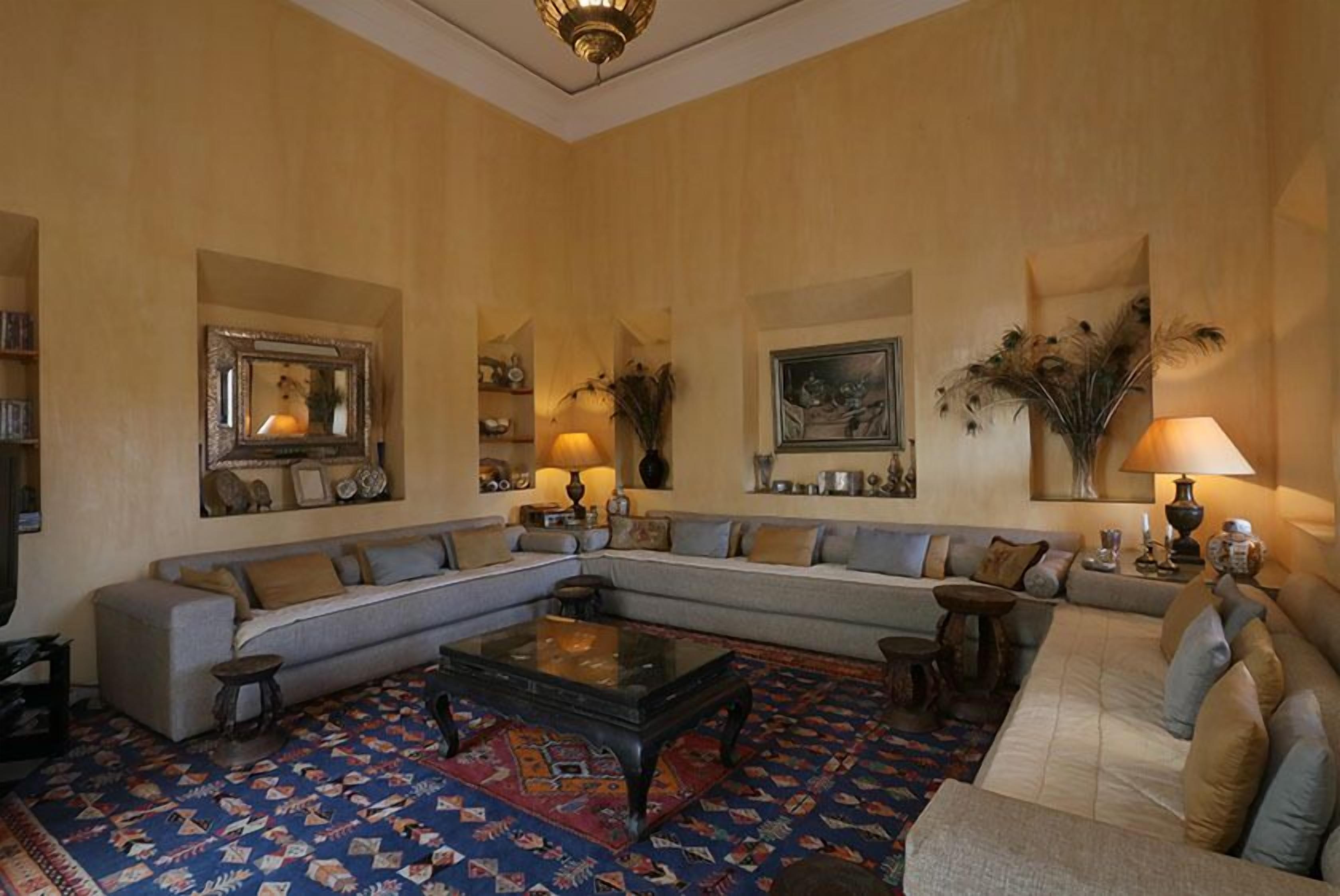 A spacious living room with a large sectional sofa, a coffee table, and a patterned rug.