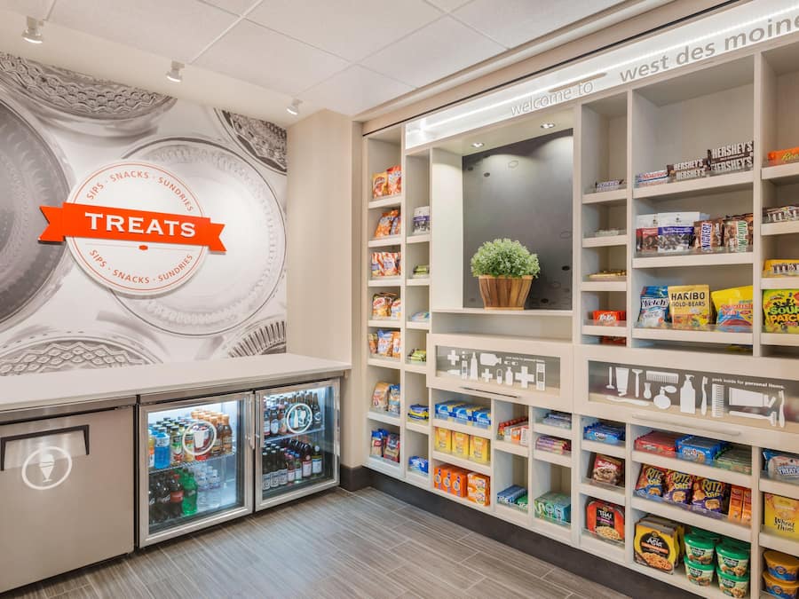 A snack and sundries section with a variety of packaged goods and a refrigerated display.