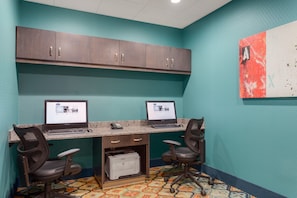 A workspace with two desks, computers, chairs, and a printer. - Hampton Inn & Suites West Des Moines/SW Mall Area (West Des Moines)
