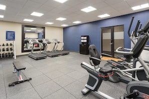 A gym with treadmills, elliptical machines, and a bench. - Hampton Inn & Suites West Des Moines/SW Mall Area (West Des Moines)