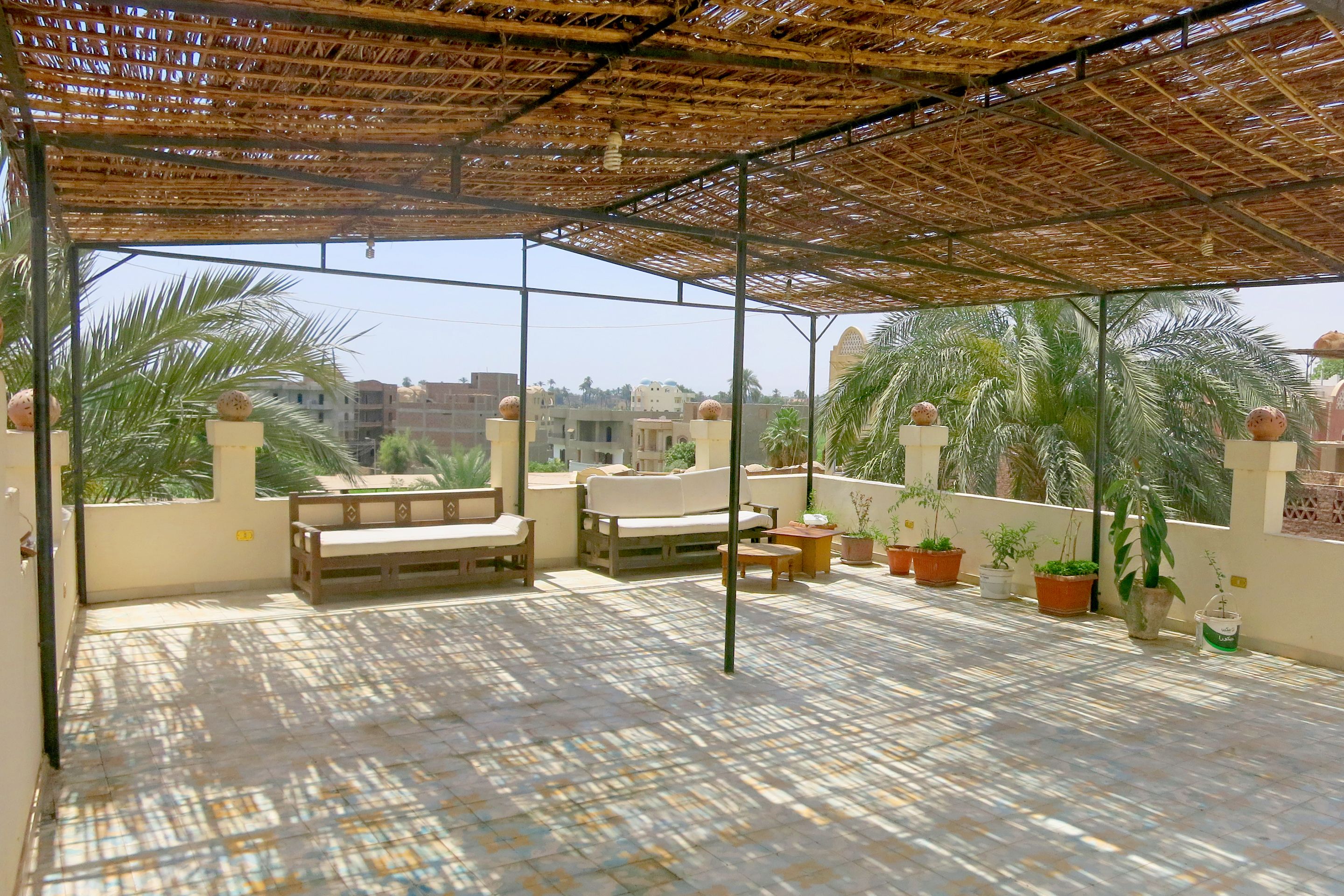 A covered outdoor seating area with a view of the cityscape.