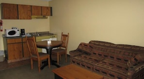 Executive Suite, 1 Bedroom, Kitchen, Mountain View | Living area | 32-inch LCD TV with cable channels, TV - The Pinecone Inn & Suites (Chetwynd)