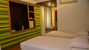 A room with two beds, a TV, and a window with a wooden frame. - Hotel Pho Sein (Yangon)