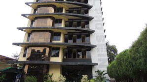A multi-story hotel with a modern design, featuring balconies on each floor and a prominent sign for the hotel. - Hotel Pho Sein (Yangon)