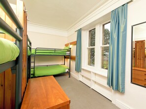 A bunk bed room with a wooden bench, a window with curtains, and a door. - YHA Buttermere - Hostel (Cockermouth)