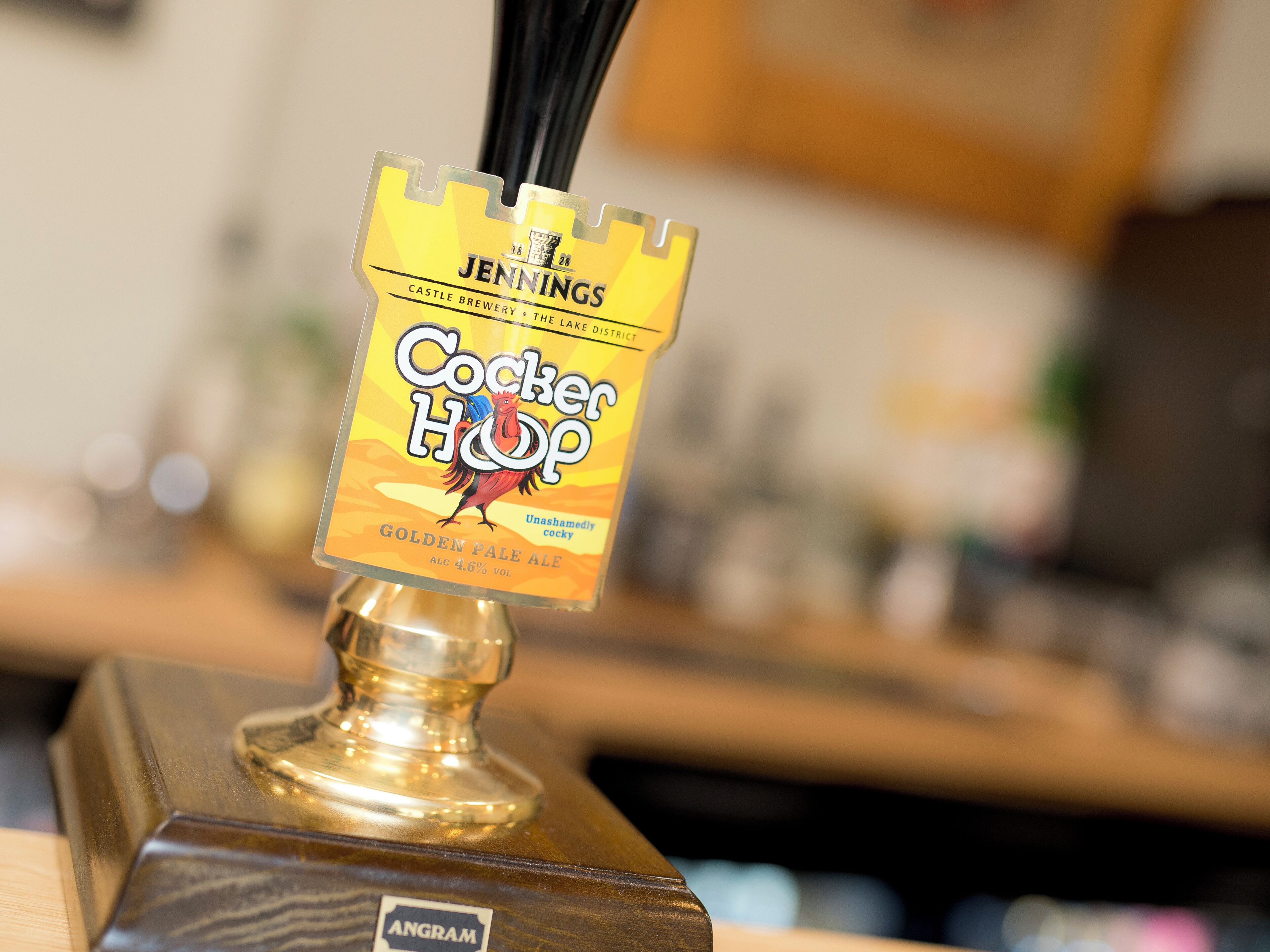 A tap labeled 'Jennings Castle Brewery - The Lake District' with a 'Cocker Hop' beer bottle.