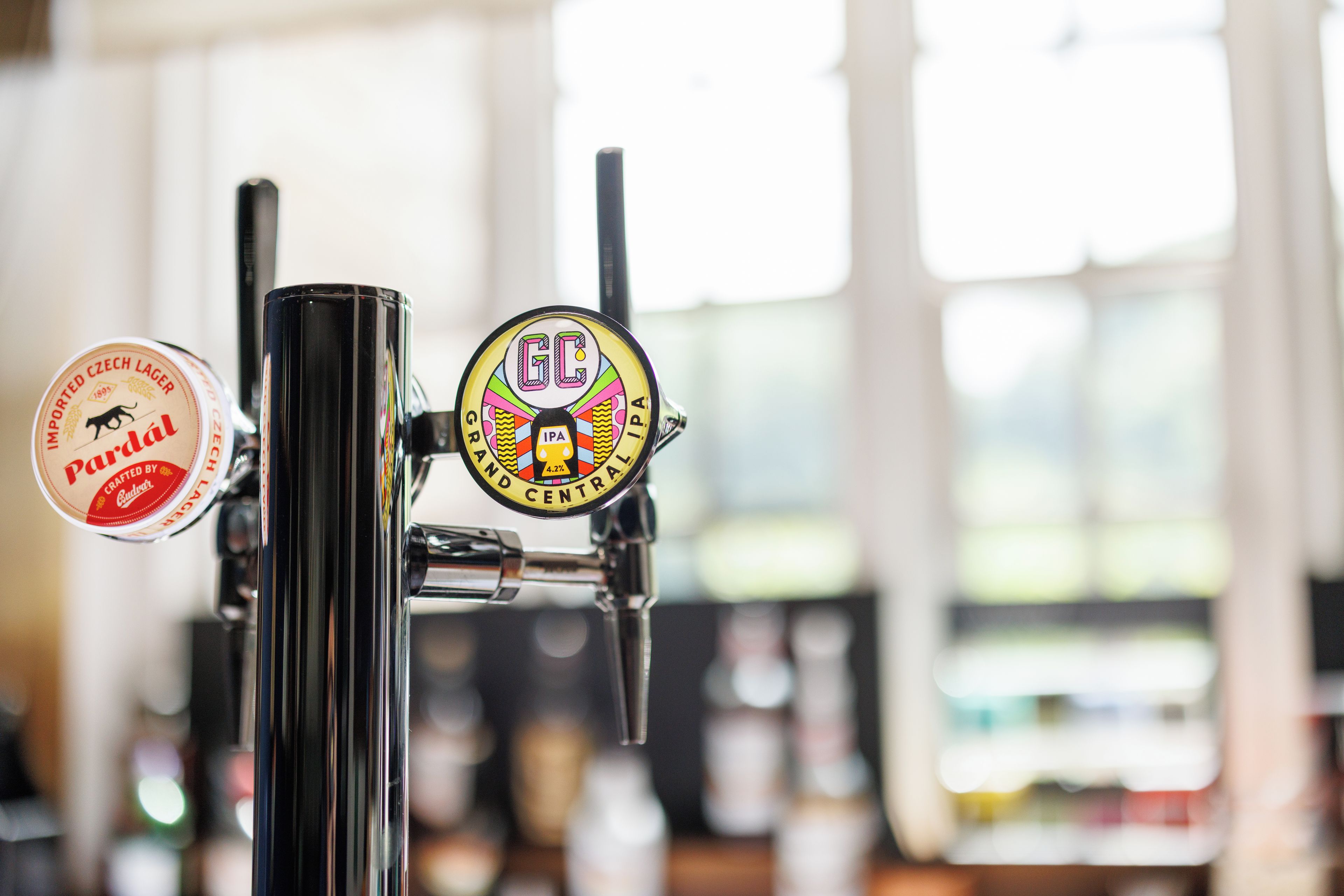 A beer tap with a colorful label and a label on the adjacent tap indicating it is a Czech lager.