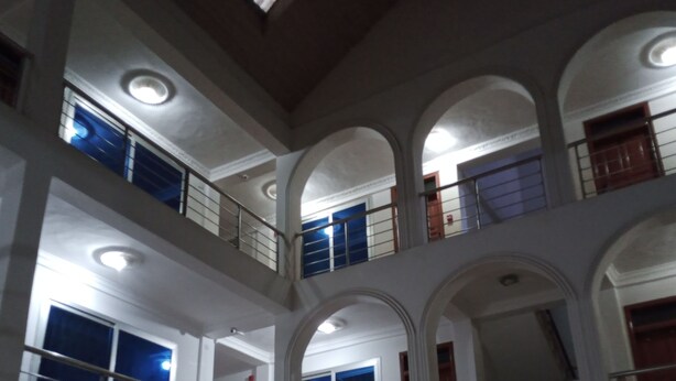 A multi-level interior with arched balconies and multiple windows. - Pemicsa Hotel (Accra)