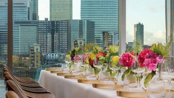 A table set for a meal with a city skyline view in the background.