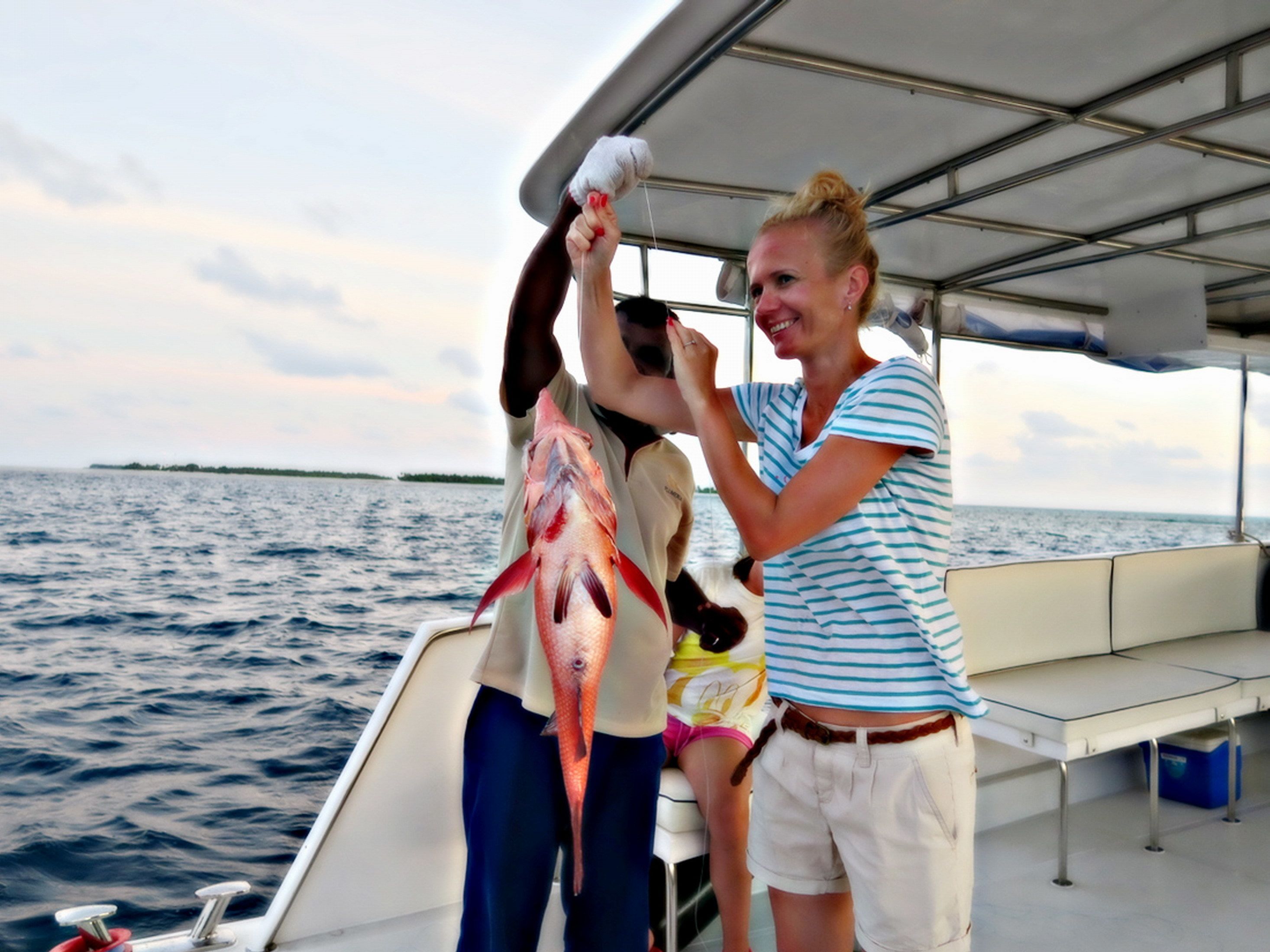A boat with a covered deck and a view of the open water.