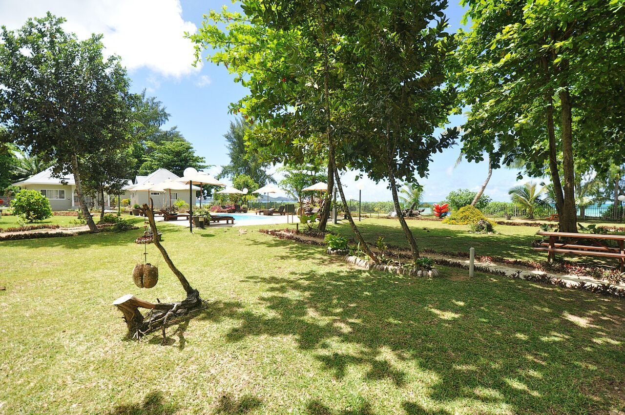 A well-maintained outdoor area with a swimming pool, picnic tables, and lounge chairs.