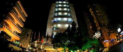 A multi-story hotel with illuminated balconies and a central atrium.
