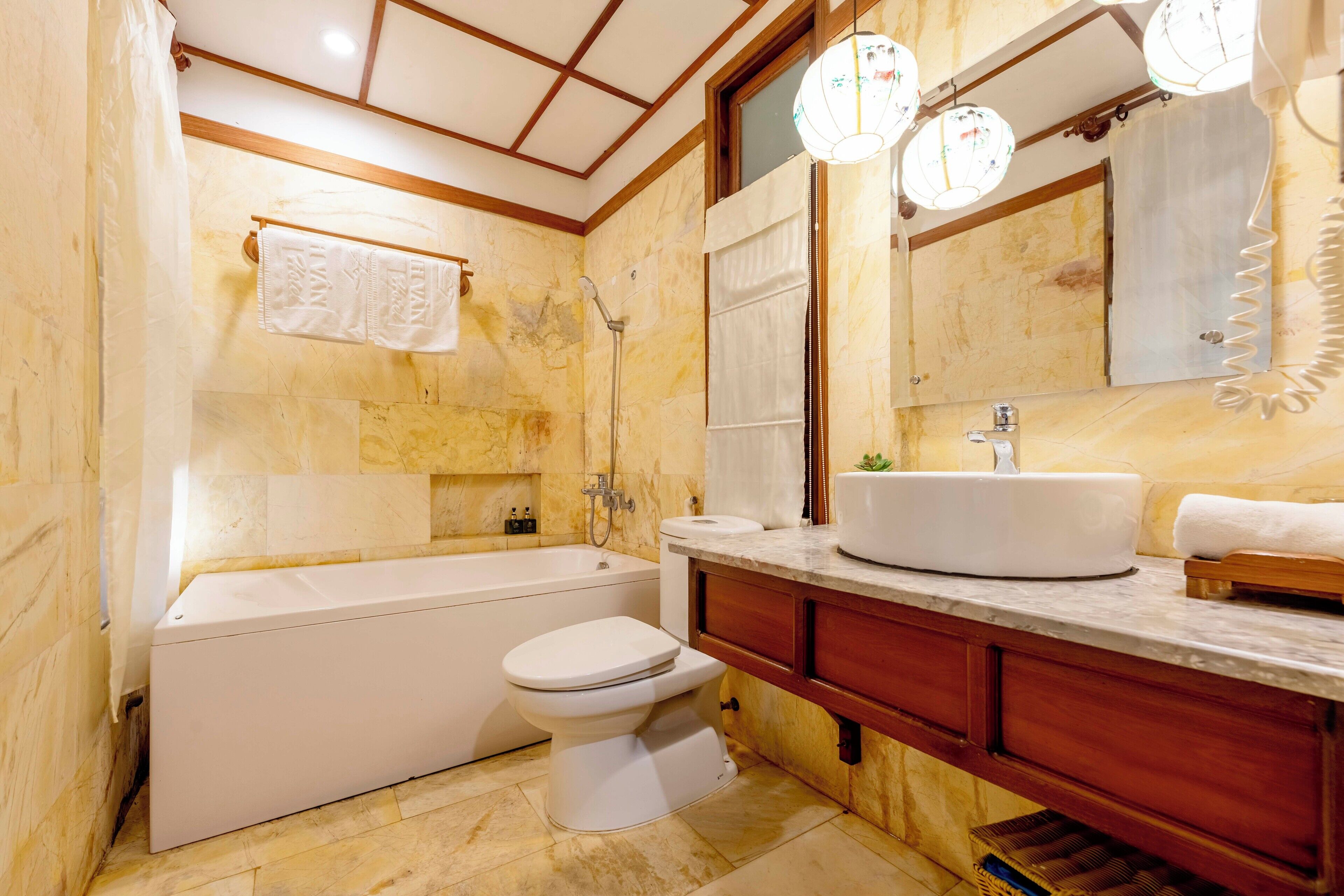 A bathroom with a bathtub, toilet, and sink.