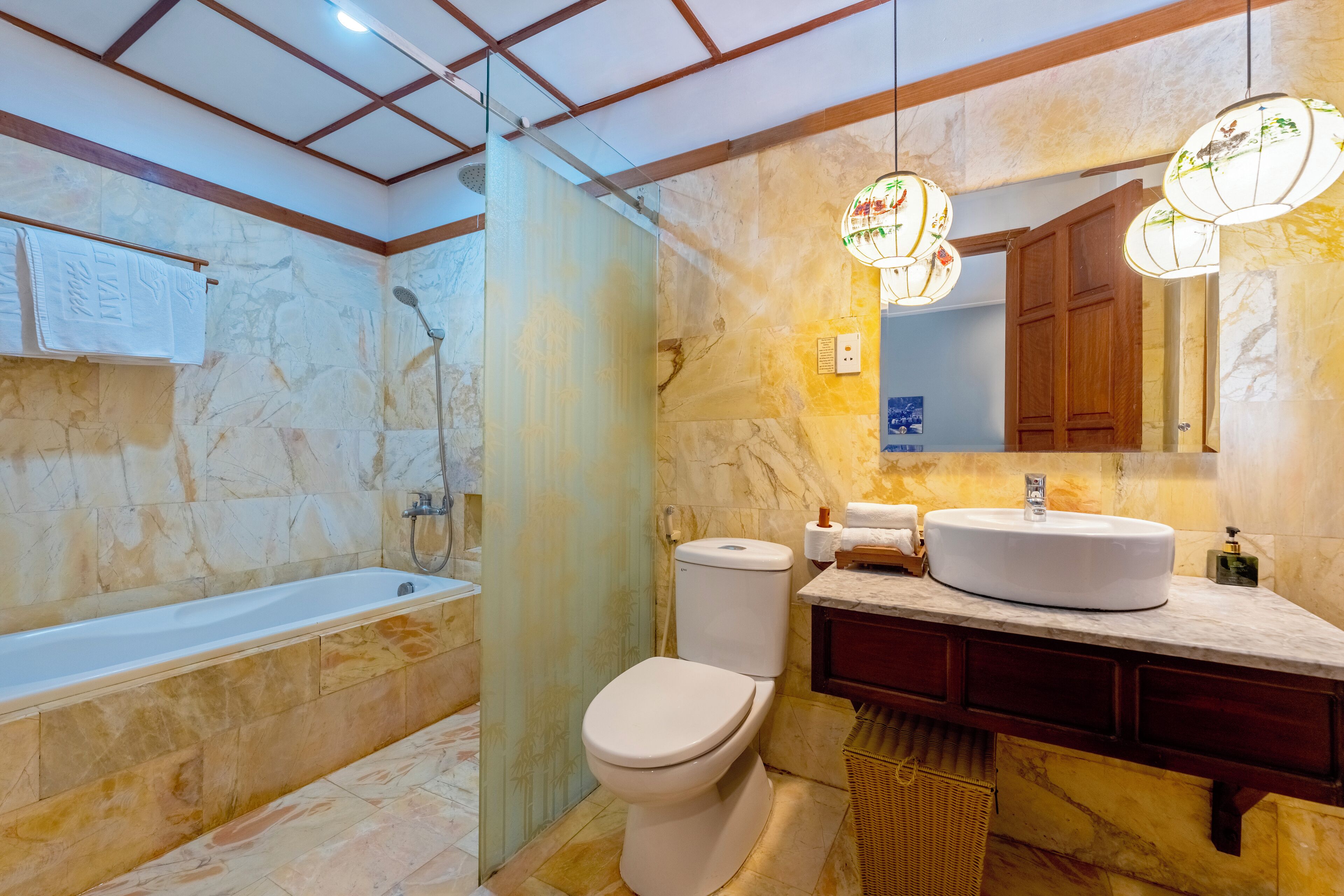A bathroom with a bathtub, toilet, and vanity with a sink.