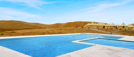 Outdoor pool, open 7 AM to 7 PM, pool umbrellas, pool loungers