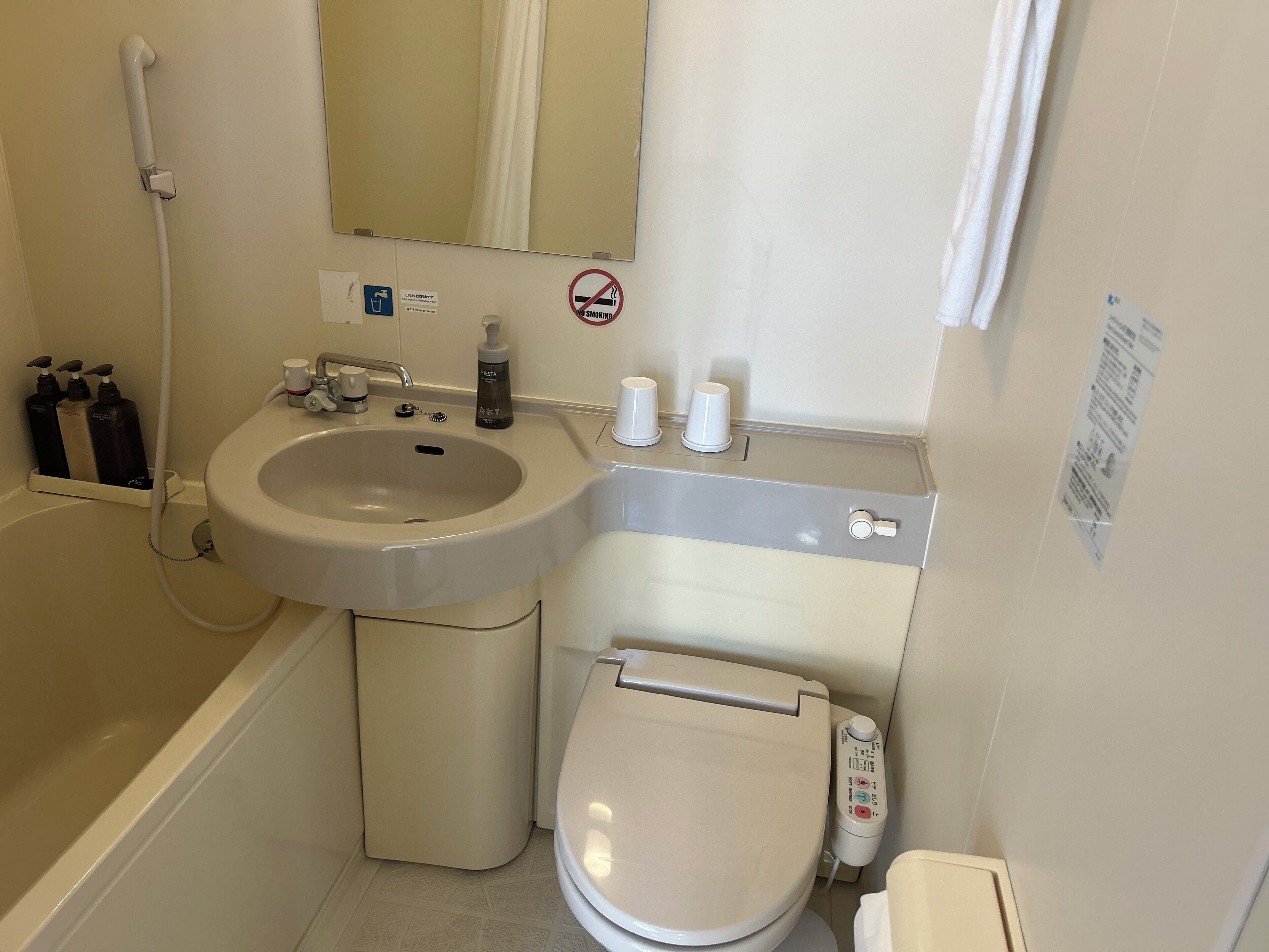 A bathroom with a sink, toilet, and shower.
