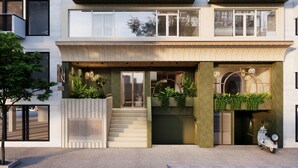 A modern hotel with a two-story facade, large windows, and outdoor plants. - NiK Hotel Nguyen Trai (Ho Chi Minh City)