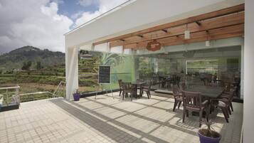 A Whistler Cafe with outdoor seating and a view of the surrounding landscape.